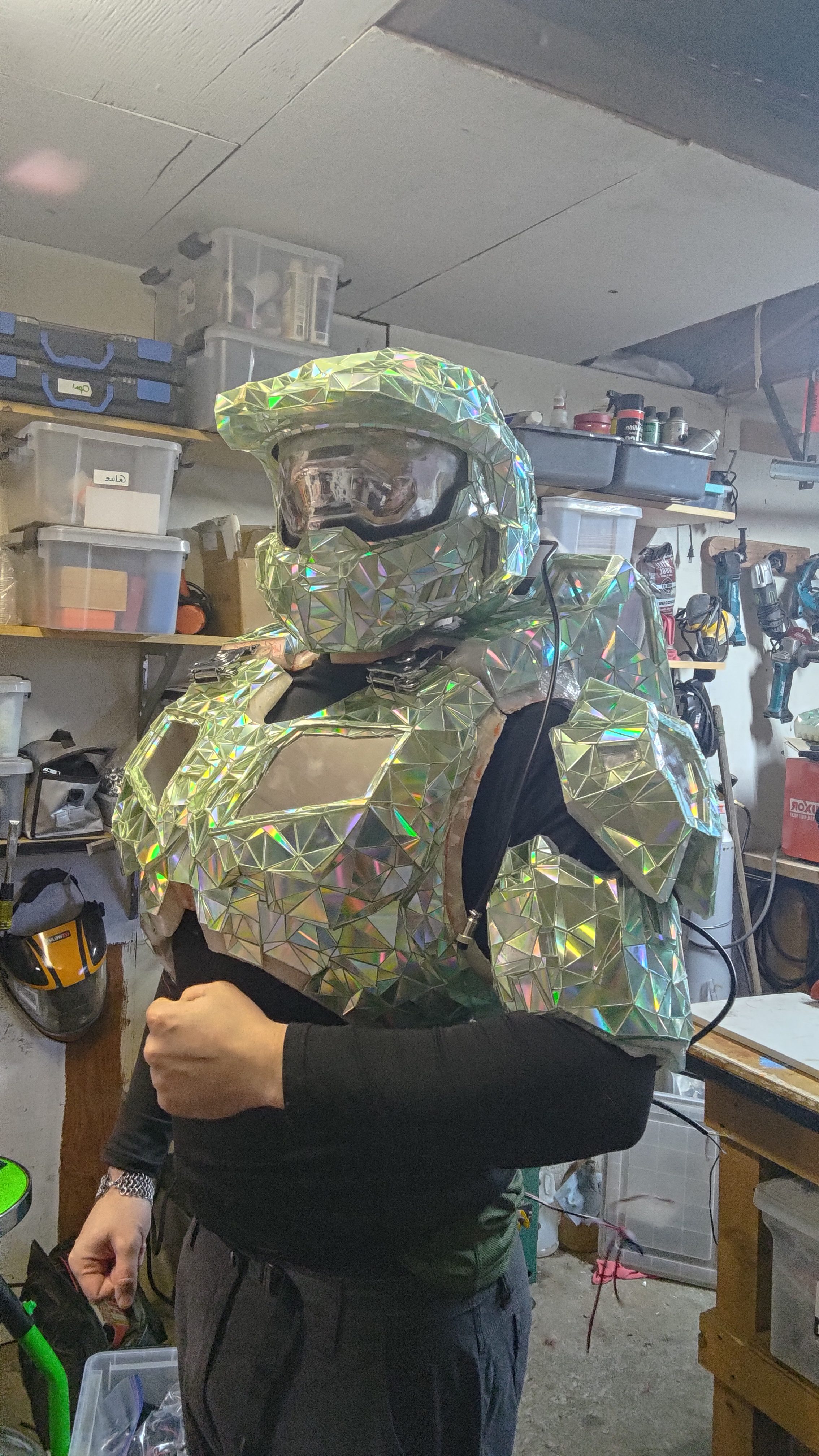 The mirrored Disco Chief armour worn in the workshop, its facets catching the shop lights.