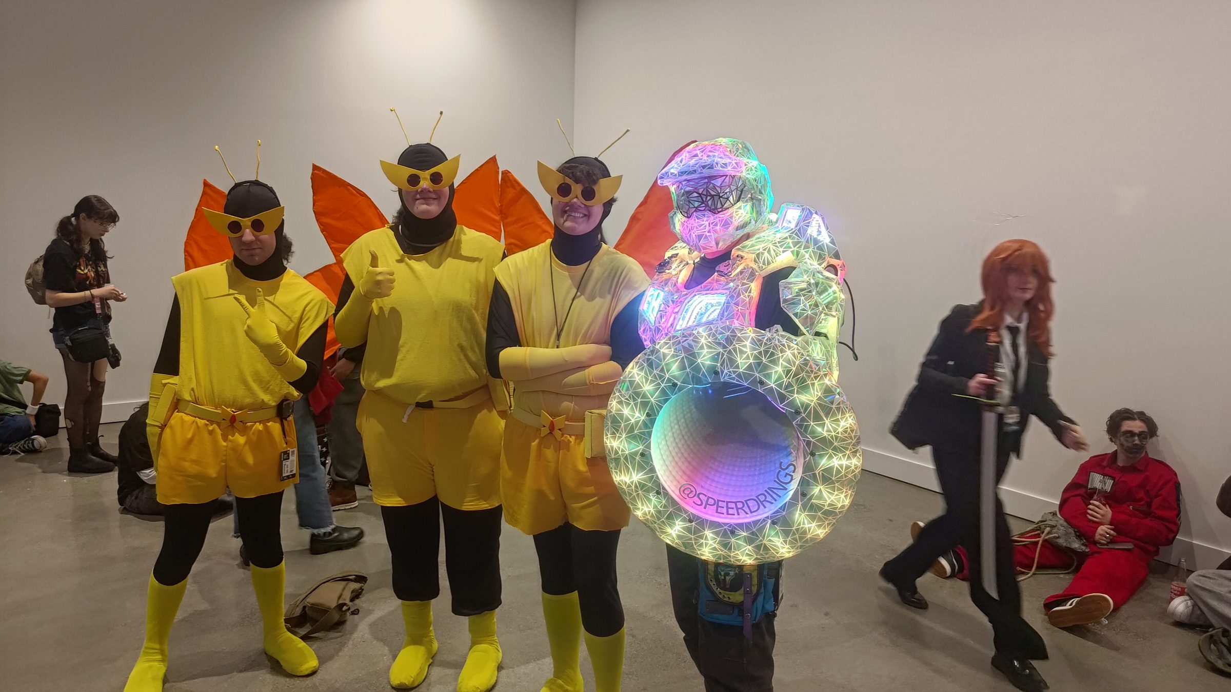 The Disco Chief armour and glowing shield with a group of cosplayers in yellow bee costumes.