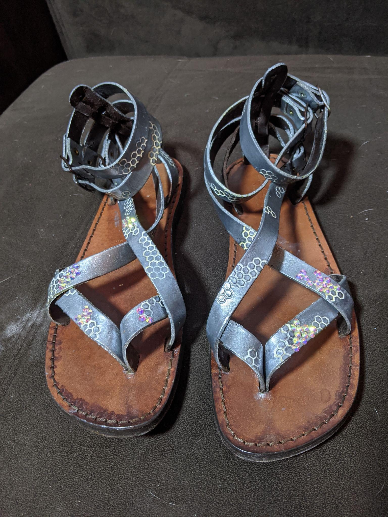 The finished sandals, their silver hexagon-stamped straps set with small clusters of rhinestones.