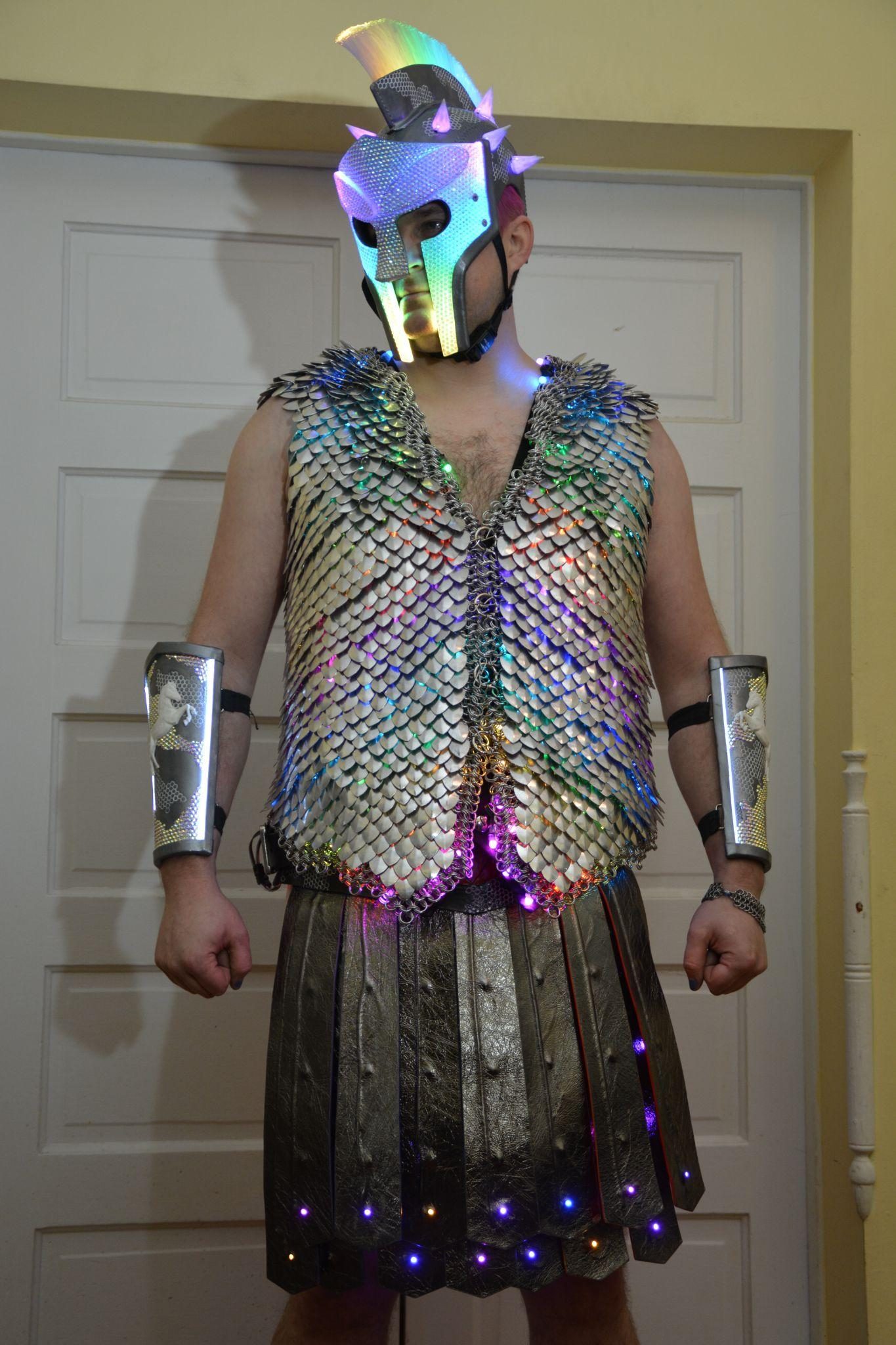 The full costume worn in a doorway, the leather kilt lit from beneath by LEDs along its lower edge.