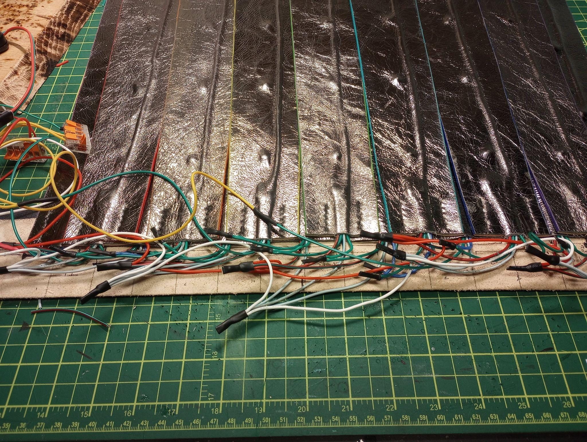 Silver kilt panels attached along the belt line, with the wiring harness and lever connectors gathered above them.