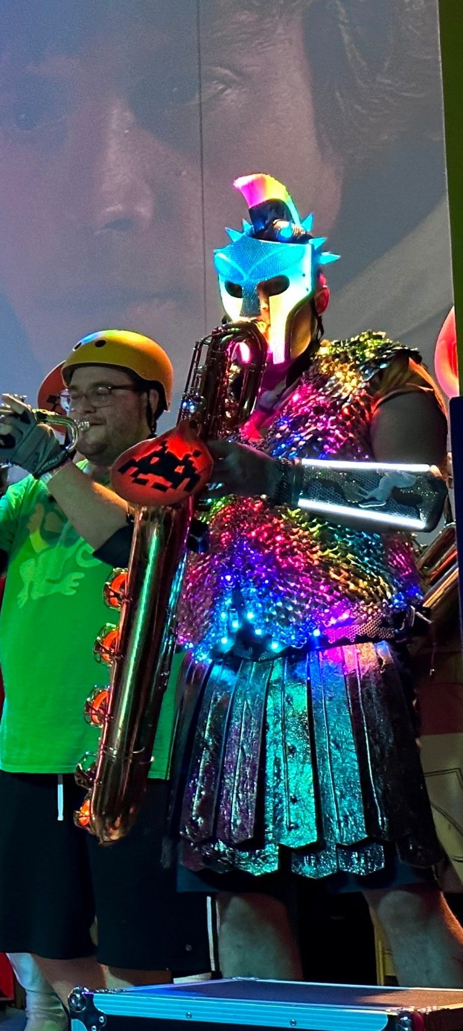 Performing with a brass band in the Russell Glow helmet and a sequinned jacket.