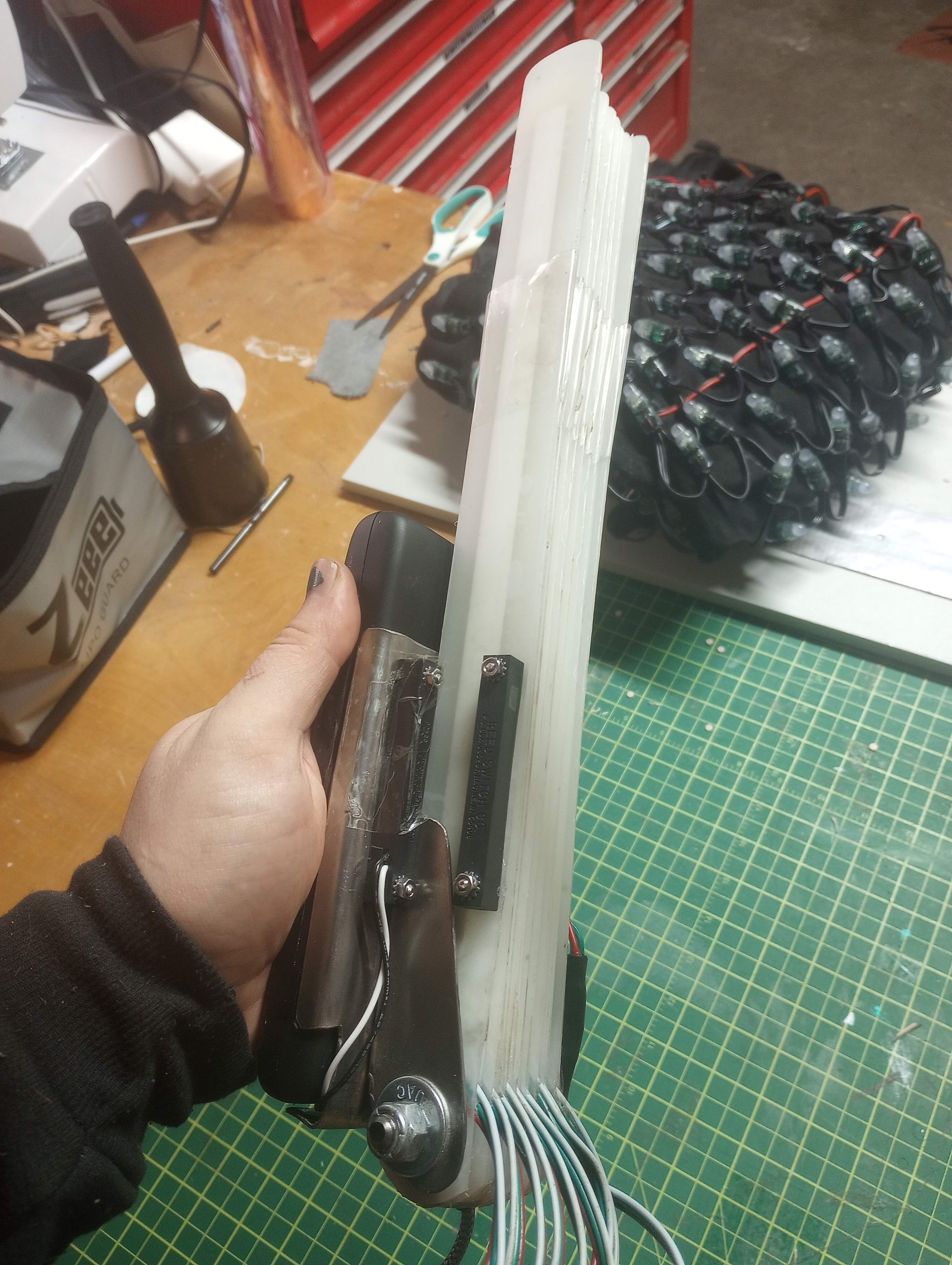 Assembling the LED hand fan at the workbench.