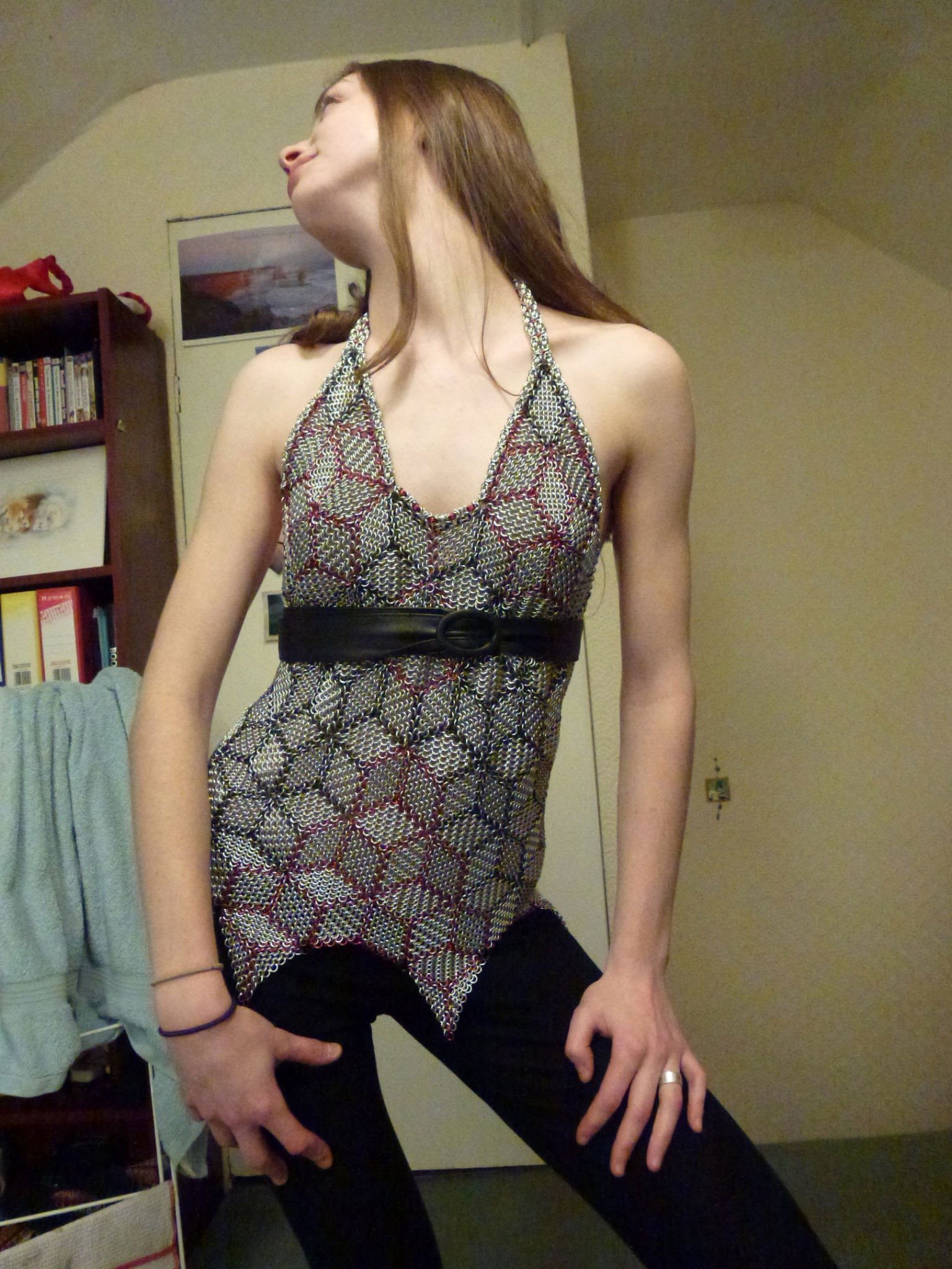 A chainmaille halter top worn with a black belt.